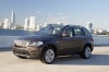 Driving 2013 BMW X5 xDrive50i in Sparkling Bronze Metallic from a front left three-quarter view